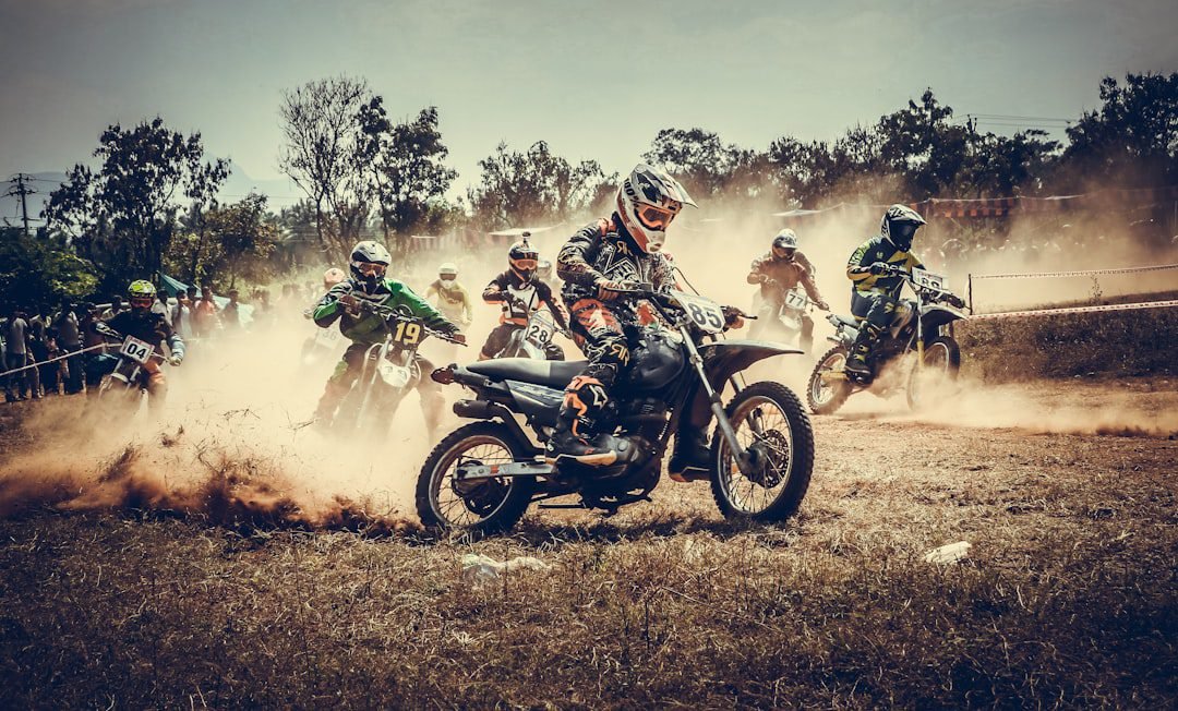 Electric dirt bike racing through dirt off-road