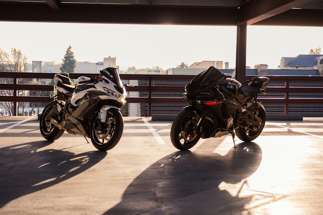 Two electric dirt bikes parked side by side for comparison