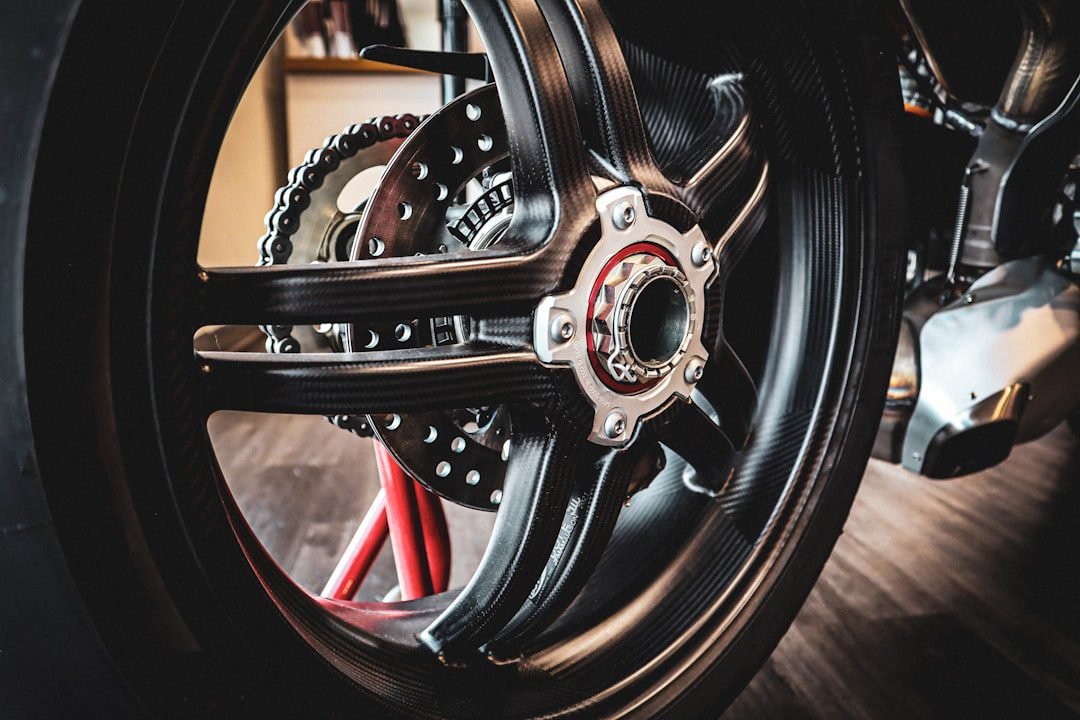 Close-up of a motorcycle wheel and chain during a tire inspection